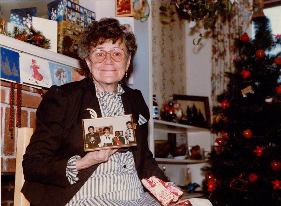 My grandmother with a photo of my siblings and me - Christmas 1980