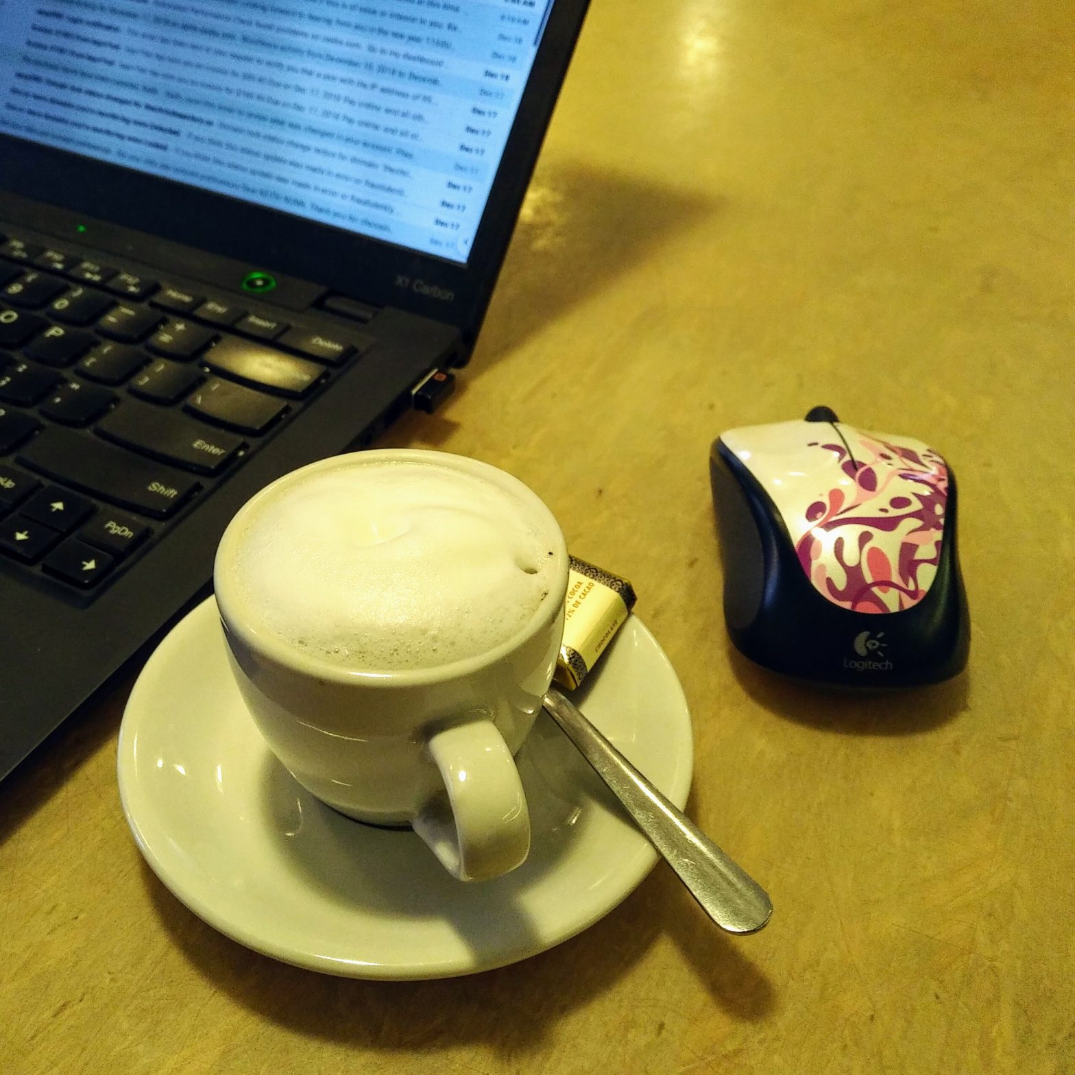 coffee computer mouse and edge of laptop