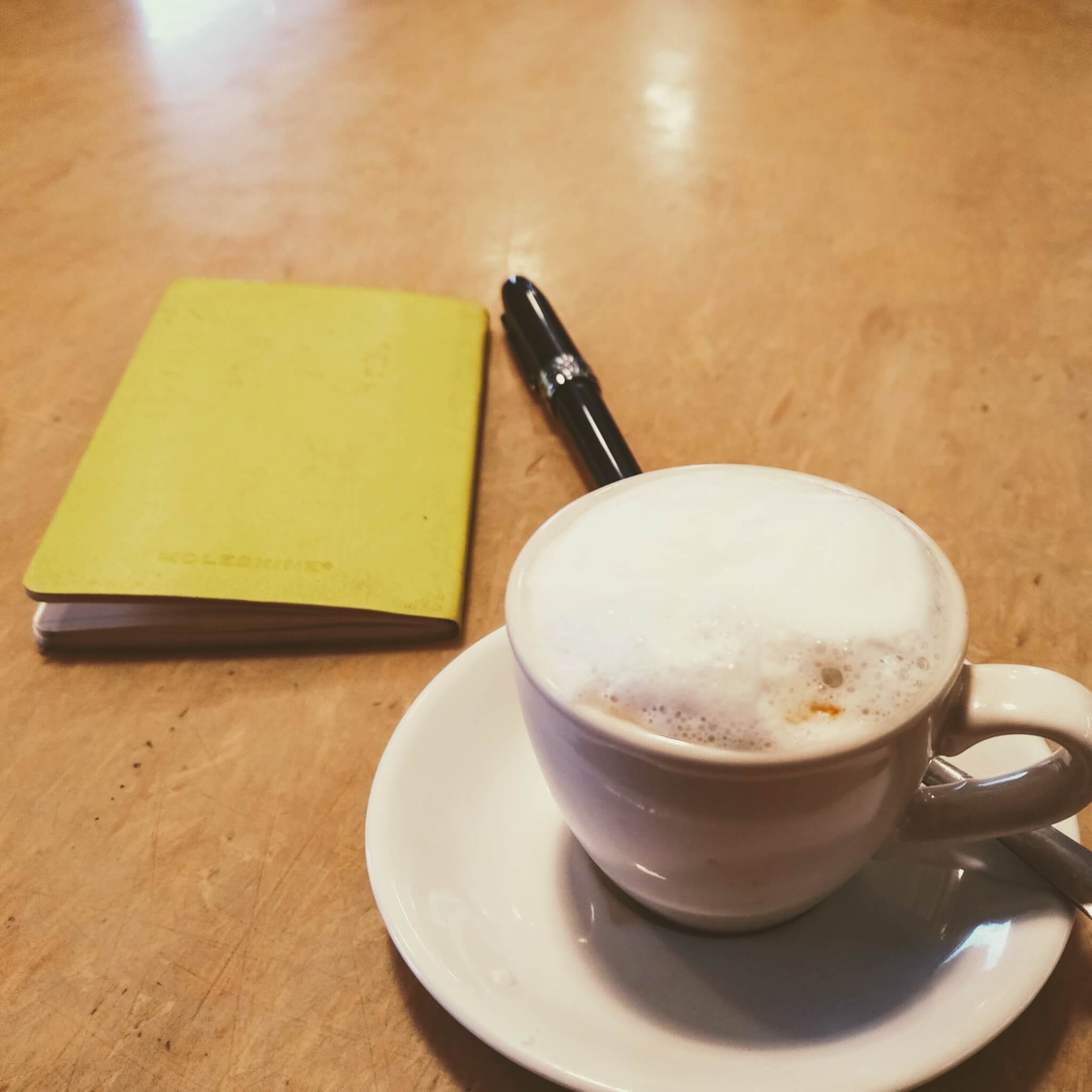 coffee, fountain pen and small notebook