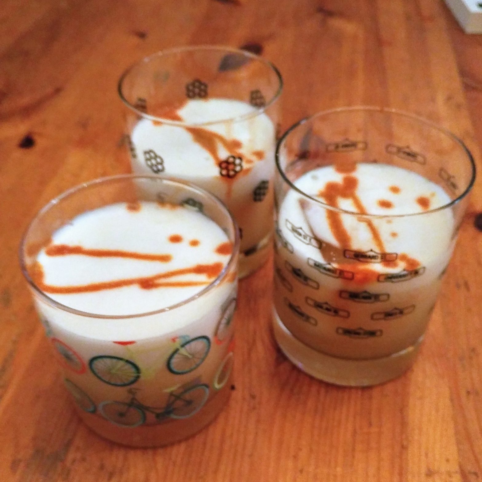 3 cocktails in rocks glasses, striped with bitters